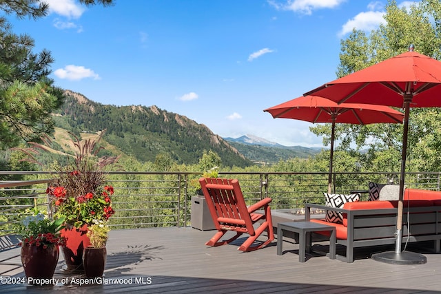 deck with outdoor lounge area and a mountain view