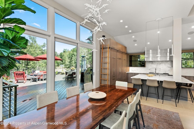 tiled dining room with vaulted ceiling