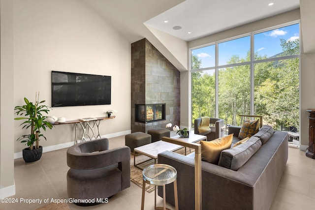 living room featuring a fireplace and a high ceiling