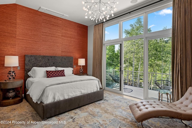 bedroom featuring access to outside and a notable chandelier