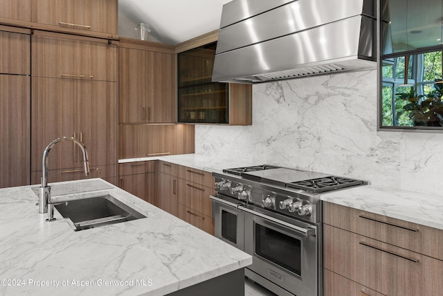 552 Mountain Laurel Dr, Aspen, CO 81611 - kitchen featuring high end stainless steel range, wall chimney exhaust hood, modern cabinets, decorative backsplash, and lofted ceiling