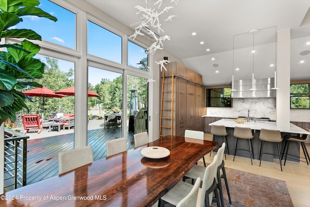 552 Mountain Laurel Dr, Aspen, CO 81611 - dining space with a barn door, recessed lighting, light tile patterned flooring, and a high ceiling