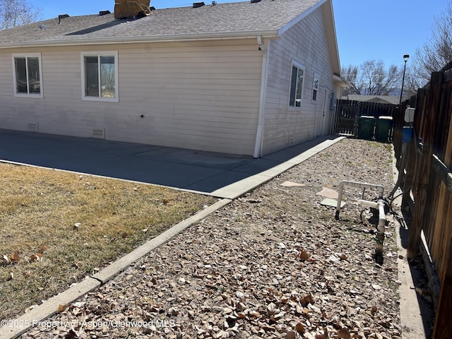 view of home's exterior featuring a patio area, a fenced backyard, crawl space, and roof with shingles