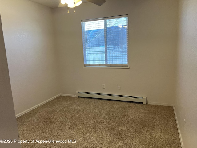 spare room with carpet floors, baseboards, and a baseboard heating unit