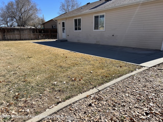 back of property featuring crawl space, a lawn, a patio area, and fence