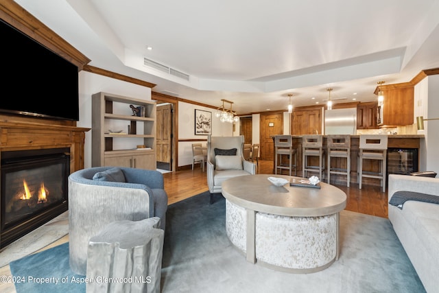 living room featuring dark hardwood / wood-style floors and a raised ceiling