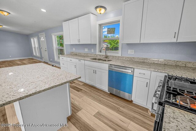 955 Sequoia Ave, Craig, CO 81625 - kitchen with dishwasher, gas range oven, white cabinetry, light stone countertops, and recessed lighting