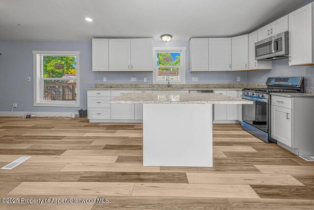 955 Sequoia Ave, Craig, CO 81625 - kitchen with appliances with stainless steel finishes, white cabinetry, light wood-type flooring, and recessed lighting