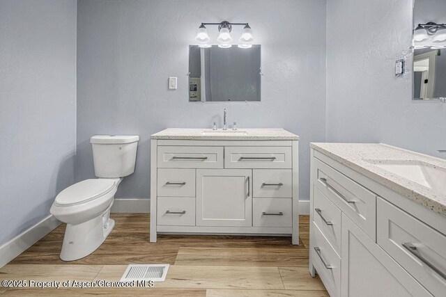 955 Sequoia Ave, Craig, CO 81625 - bathroom with two vanities and wood finished floors