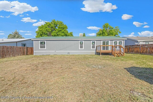 955 Sequoia Ave, Craig, CO 81625 - back of house with a deck, a fenced backyard, and a metal roof