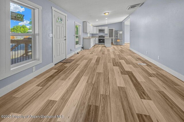 955 Sequoia Ave, Craig, CO 81625 - unfurnished living room with light wood-style floors and vaulted ceiling