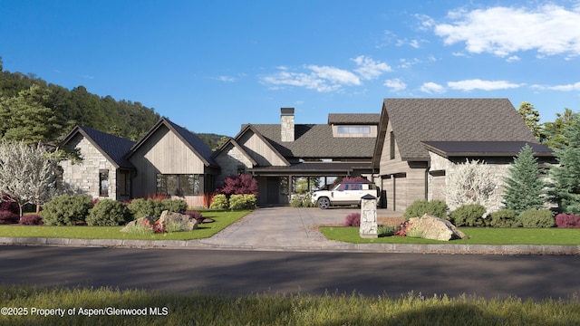 1042 Bald Eagle Way, Carbondale, CO 81623 - view of front facade featuring a chimney, stone siding, and roof with shingles