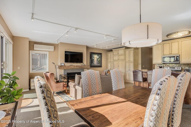 150 Snowmass Club Cir Unit 1623, Snowmass Village, CO 81615 - dining room with track lighting, a wall mounted air conditioner, and a fireplace