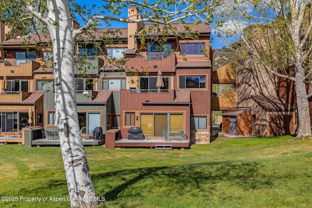 150 Snowmass Club Cir Unit 1623, Snowmass Village, CO 81615 - rear view of property with a chimney, a lawn, and a deck