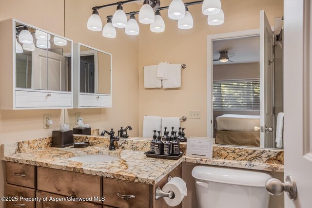 150 Snowmass Club Cir Unit 1623, Snowmass Village, CO 81615 - bathroom featuring connected bathroom, toilet, vanity, and ceiling fan