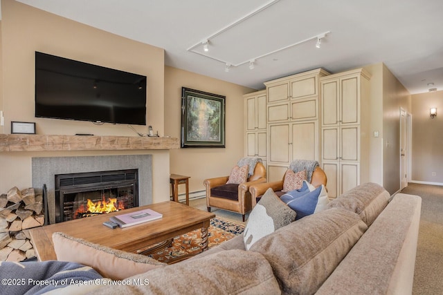 150 Snowmass Club Cir Unit 1623, Snowmass Village, CO 81615 - carpeted living room with a high end fireplace, baseboards, a baseboard heating unit, and rail lighting