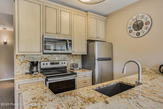 150 Snowmass Club Cir Unit 1623, Snowmass Village, CO 81615 - kitchen featuring stainless steel appliances, a sink, light stone countertops, decorative backsplash, and cream cabinetry