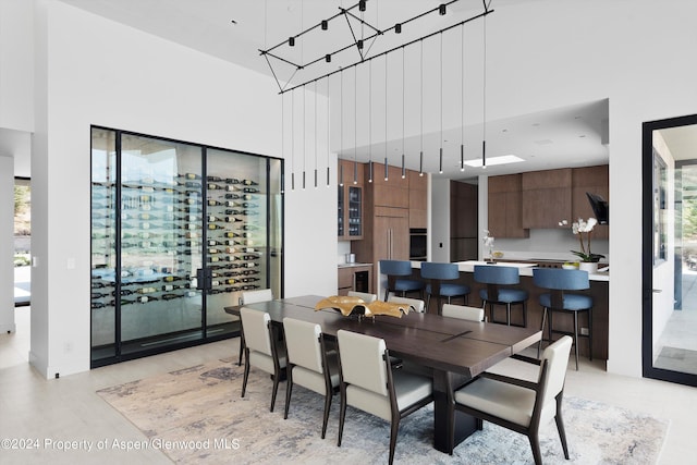 dining space with a towering ceiling