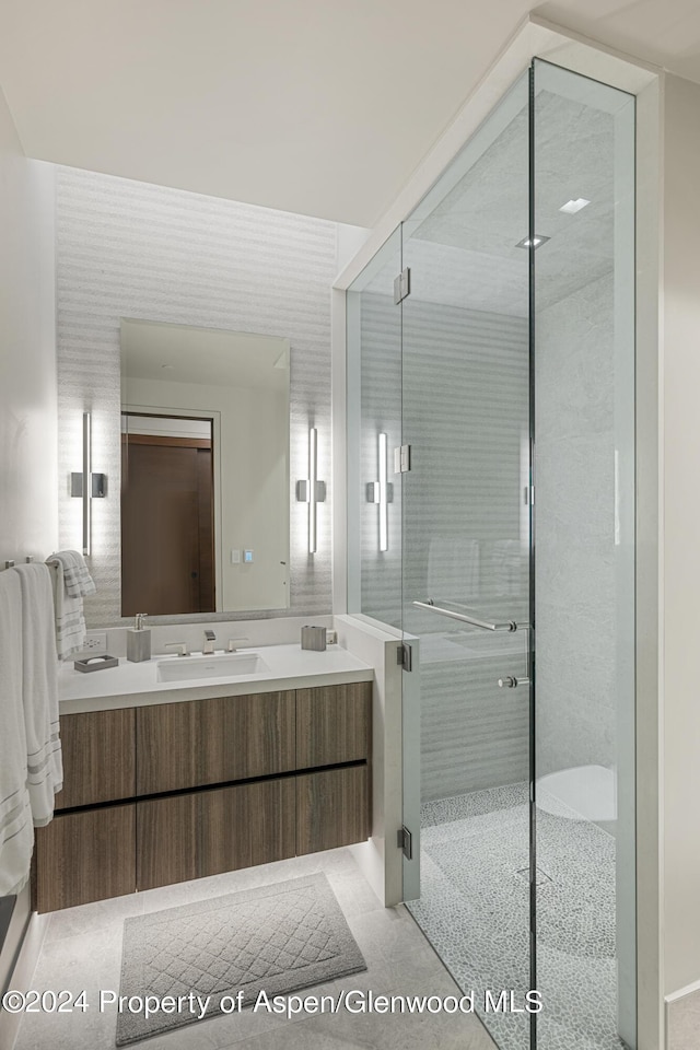 bathroom featuring tile patterned floors, vanity, and an enclosed shower