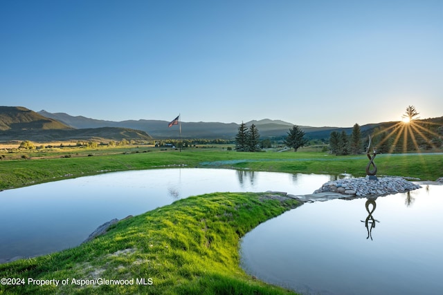 surrounding community featuring a yard and a water and mountain view