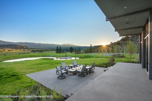 view of patio / terrace featuring a mountain view and an outdoor fire pit