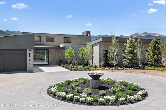 contemporary home featuring a mountain view and a garage