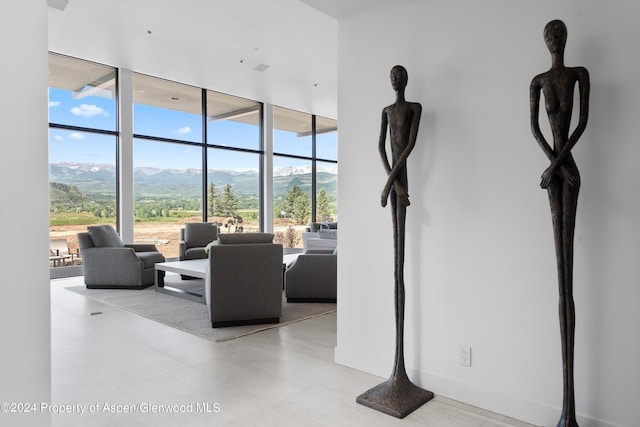 living room with a mountain view and floor to ceiling windows