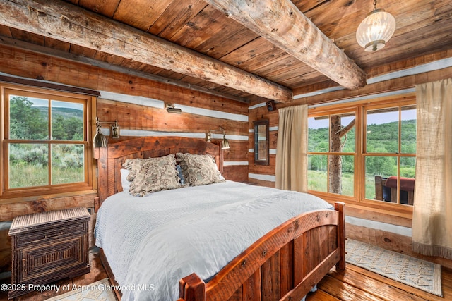 1350 Old Herron Rd, Basalt, CO 81621 - bedroom featuring a wood ceiling with exposed beams, multiple windows, hardwood / wood-style flooring, and wooden walls