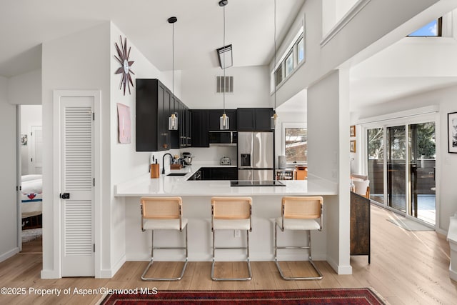 1625 Cooper Ave, Glenwood Springs, CO 81601 - kitchen featuring visible vents, a sink, appliances with stainless steel finishes, dark cabinets, and a breakfast bar area