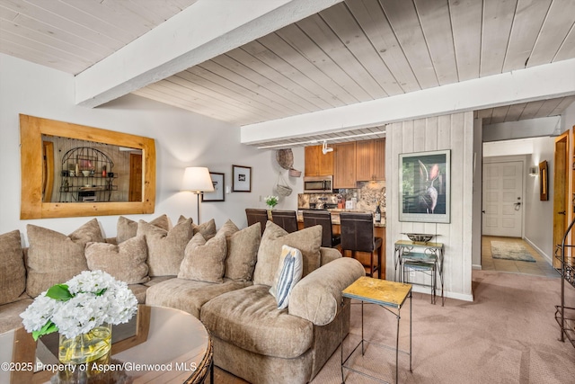 131 E Durant Ave Unit 202, Aspen, CO 81611 - living area featuring light carpet, wood ceiling with exposed beams, and baseboards