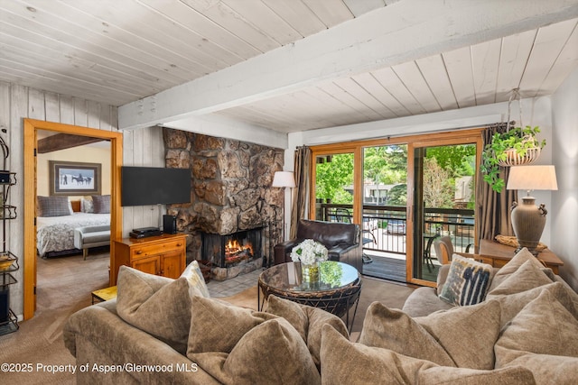 131 E Durant Ave Unit 202, Aspen, CO 81611 - living area with carpet flooring, a fireplace, wood ceiling, and wooden walls