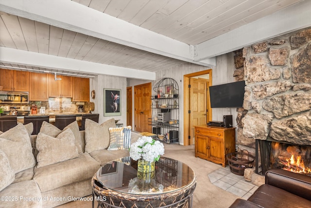 131 E Durant Ave Unit 202, Aspen, CO 81611 - living room with light colored carpet, wooden ceiling with exposed beams, a fireplace, and wood walls