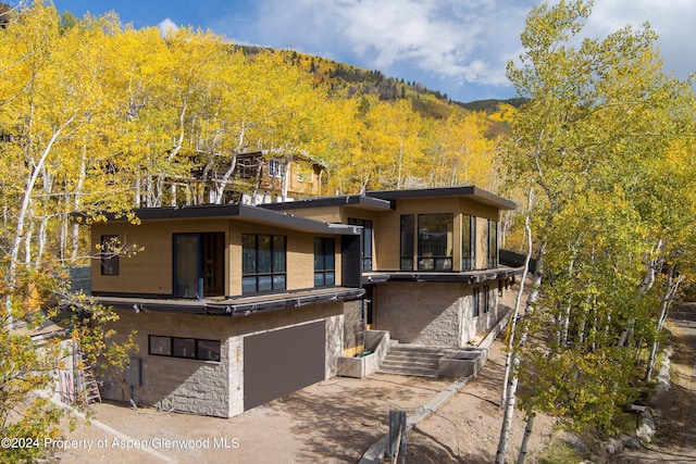 view of front of property with a mountain view and a garage