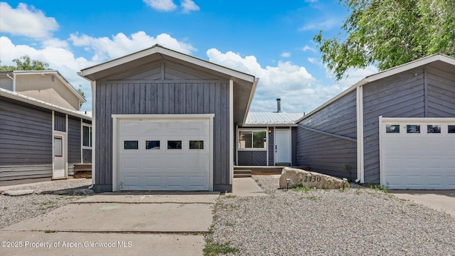 2430 W Ave, Rifle, CO 81650 - view of front of property featuring a metal roof, an attached garage, and concrete driveway