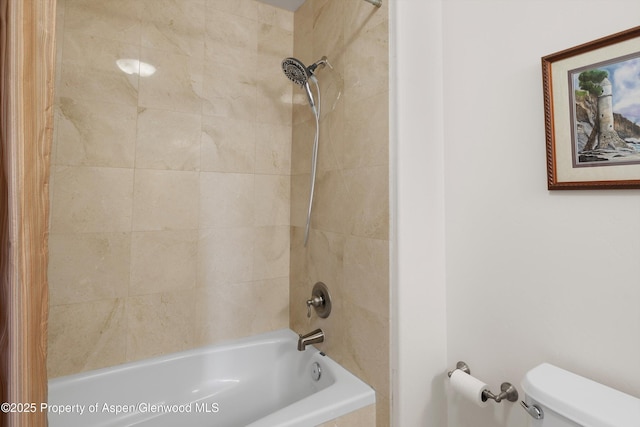 bathroom featuring tub / shower combination and toilet