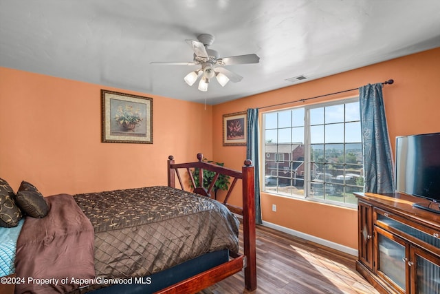 bedroom with ceiling fan and hardwood / wood-style floors