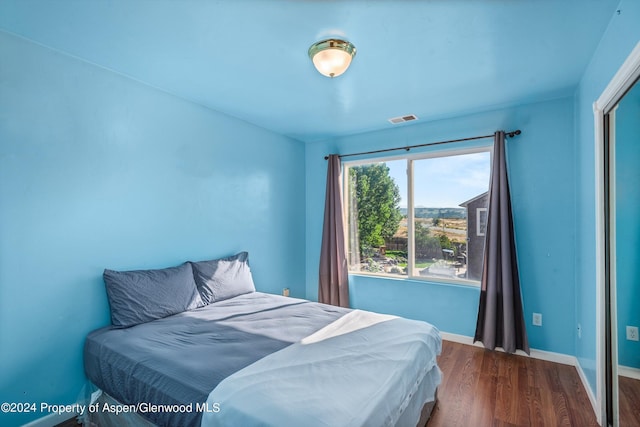 bedroom with hardwood / wood-style floors