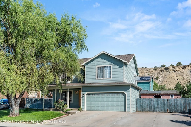 front of property with a front yard and a garage