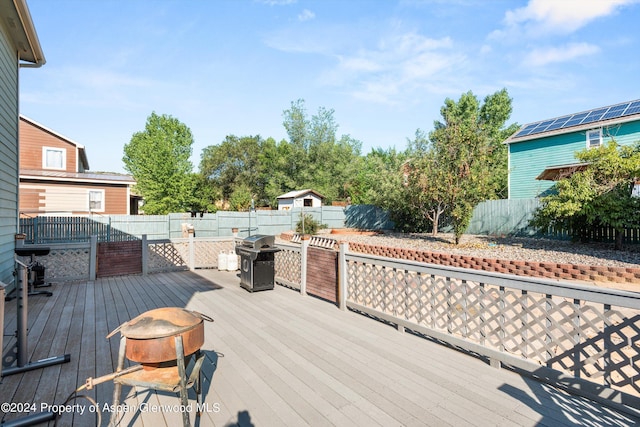 wooden deck featuring a grill