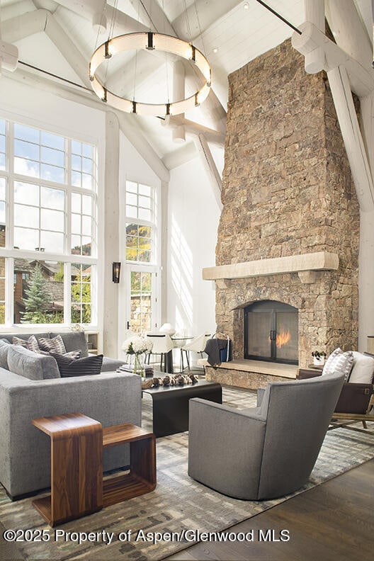 87 Thunderbowl Ln, Aspen, CO 81611 - living area featuring high vaulted ceiling, wood finished floors, a fireplace, and beam ceiling