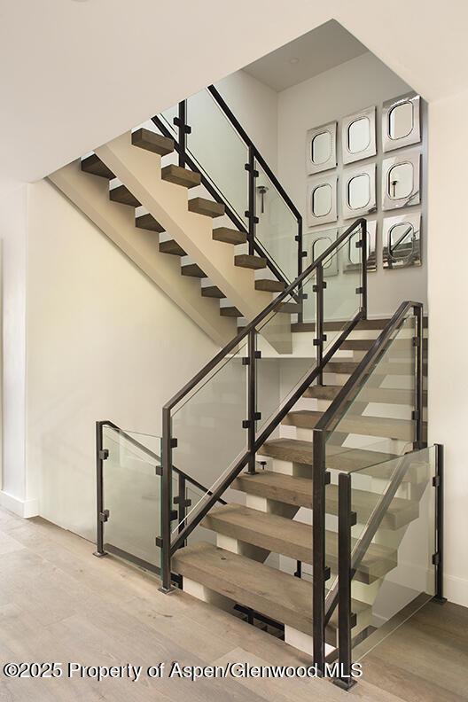 87 Thunderbowl Ln, Aspen, CO 81611 - staircase featuring baseboards and wood finished floors