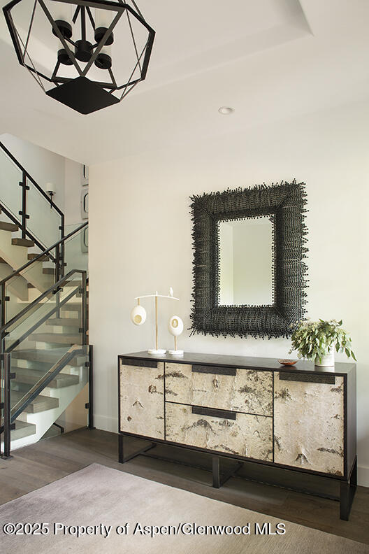 87 Thunderbowl Ln, Aspen, CO 81611 - stairway featuring a chandelier and wood finished floors