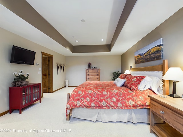 bedroom featuring a raised ceiling, carpet flooring, recessed lighting, and baseboards