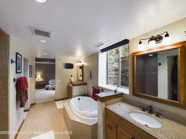 full bathroom with ensuite bath, a garden tub, visible vents, and a sink