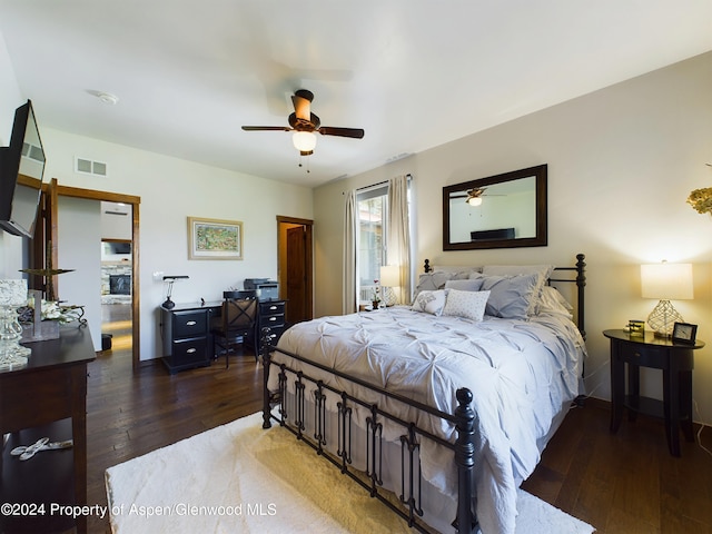 bedroom with visible vents, ceiling fan, and hardwood / wood-style flooring