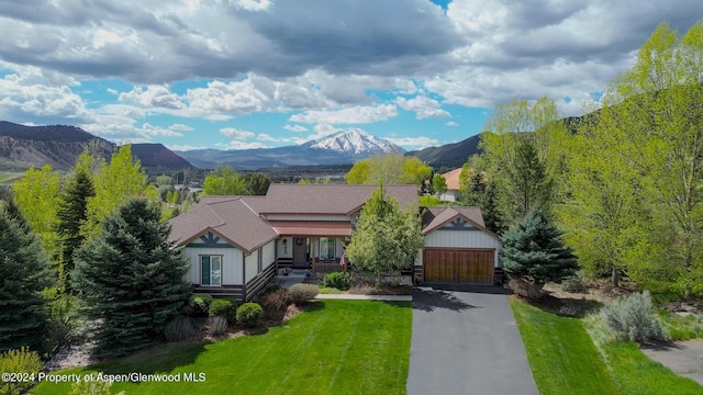 view of front facade with a front yard and a mountain view