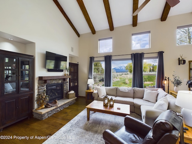 living area featuring a stone fireplace, beamed ceiling, high vaulted ceiling, and dark wood-style flooring