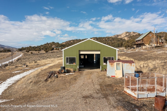 view of pole building featuring driveway and a mountain view