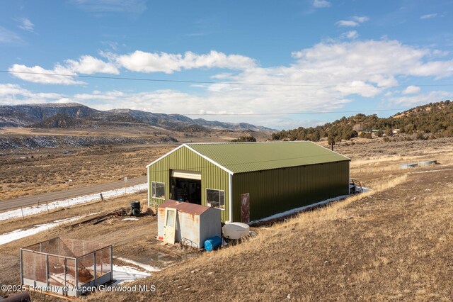 view of outdoor structure featuring a mountain view and an outdoor structure