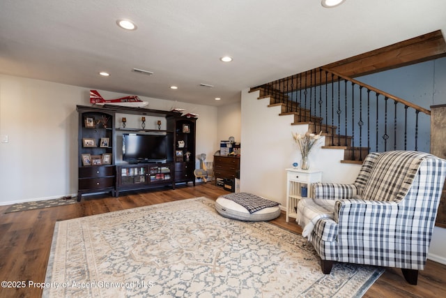 living area featuring recessed lighting, visible vents, stairway, wood finished floors, and baseboards